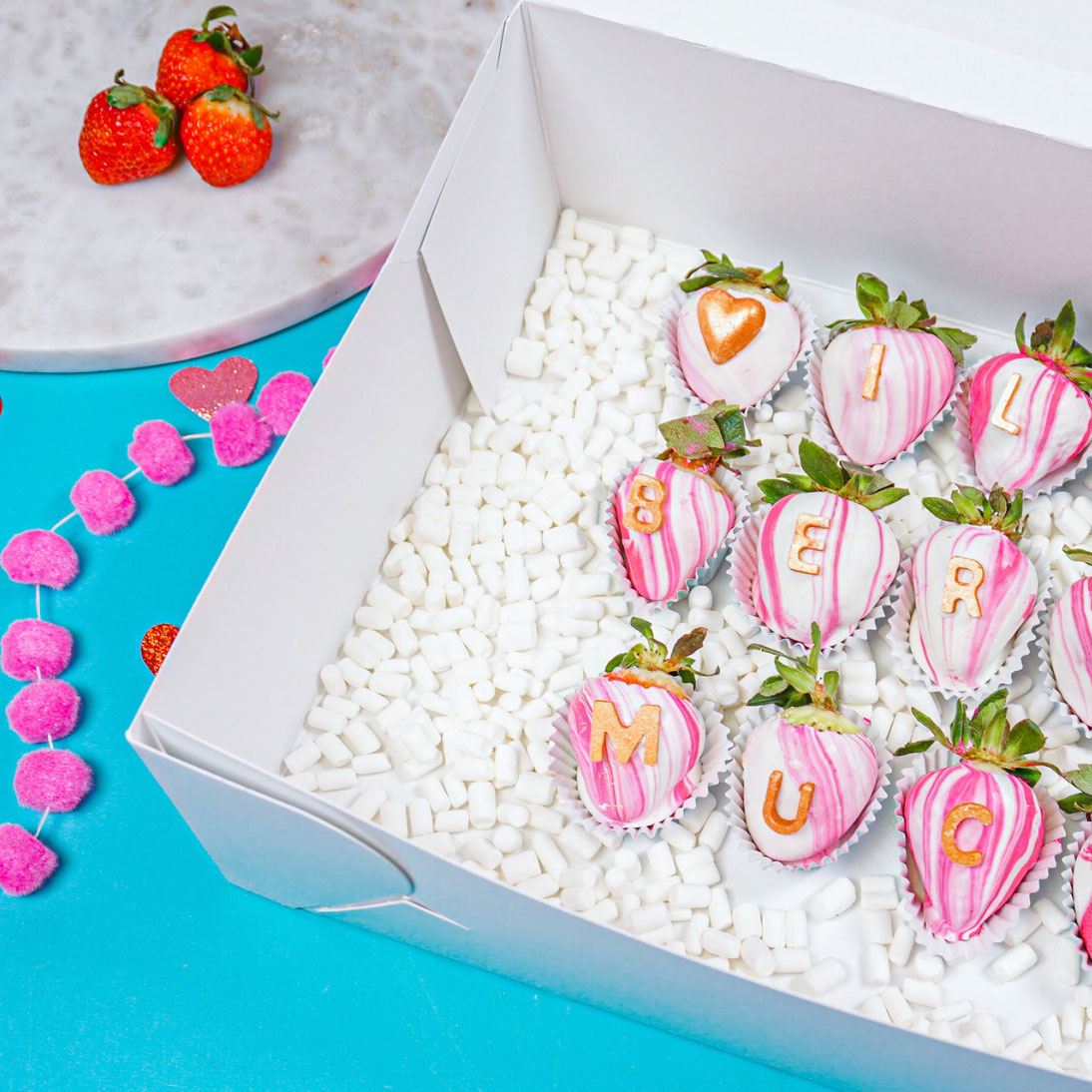 pink marbled chocolate strawberries in cake box with marshmallow filler