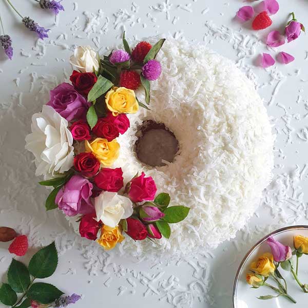 coconut and fresh flower decorated bundt cake