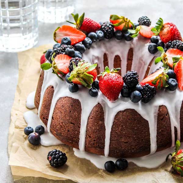 bundt cake topped with different berries