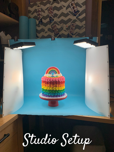 indoor photograpy studio setup with four lights and rainbow cake subject