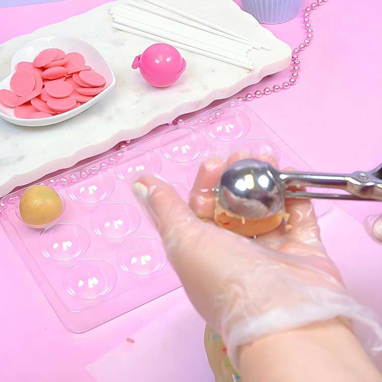 using a cookie scoop to make cake pops