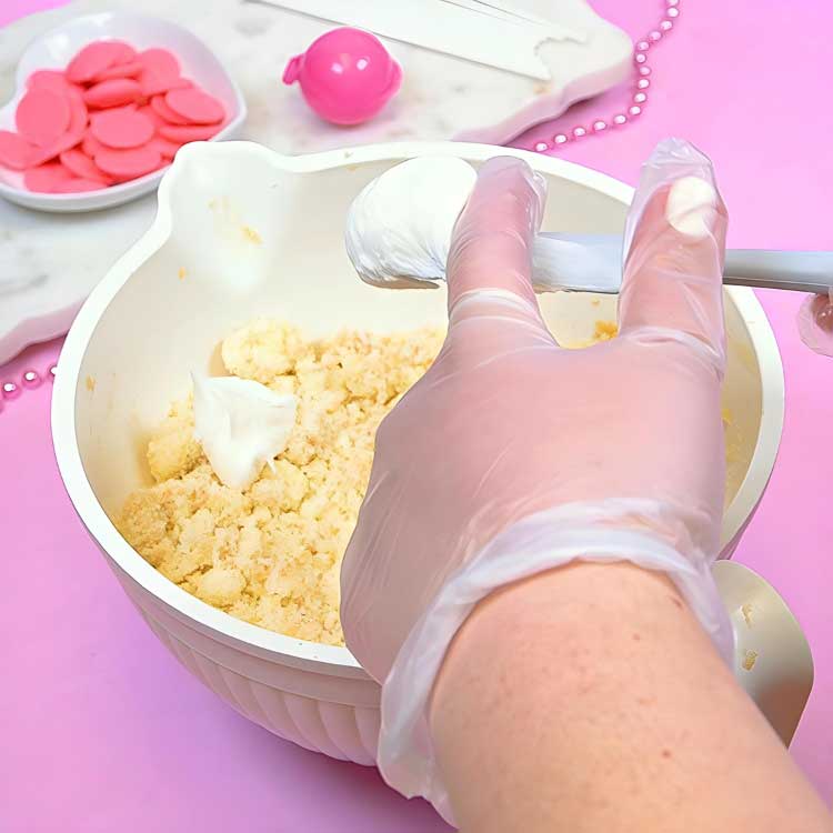 cake crumbled into bowl with icing to make cake pop dough
