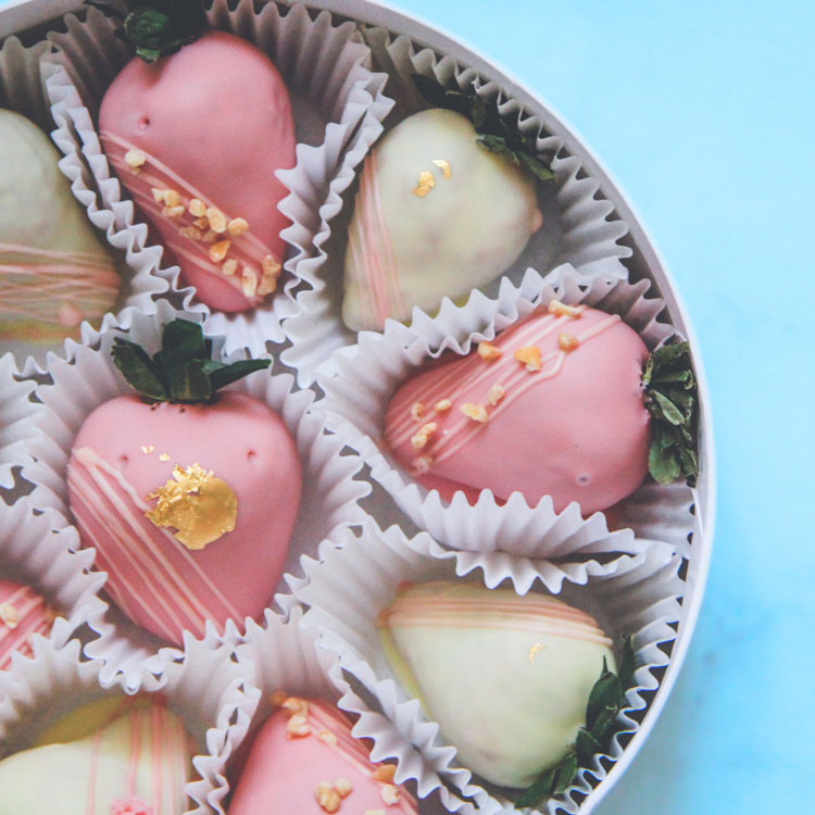 close-up of strawberries in a bowl being washed