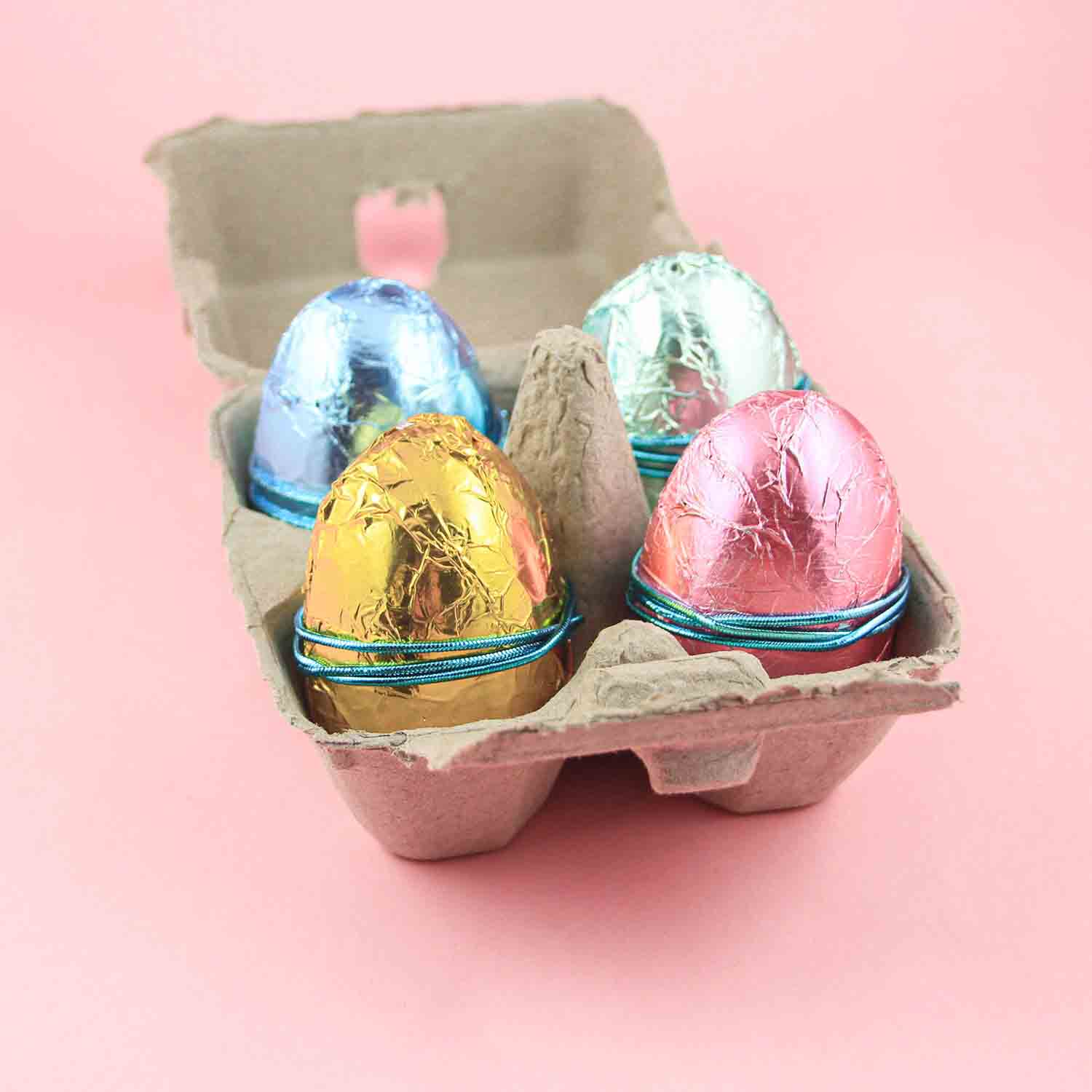 foil wrapped peanut butter eggs in an egg carton.