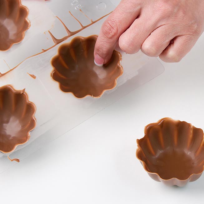 use finger tip to gently remove chocolate cup from mold.