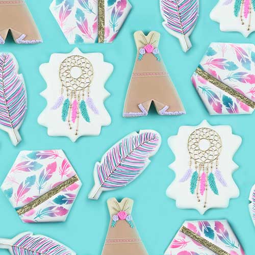 Tribal cookies decorated in royal icing featuring Teepee, dream catcher, feather and airbrushed feather cookies. Colors used are pink, purple green and gold with gold accents and flowers.