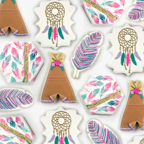 Tribal cookies decorated in royal icing featuring Teepee, dream catcher, feather and airbrushed feather cookies. Colors used are pink, purple green and gold with gold accents and flowers.