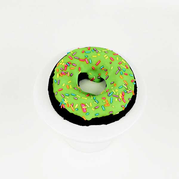 Vibrant green iced chocolate doughnut with rainbow shimmer jimmies