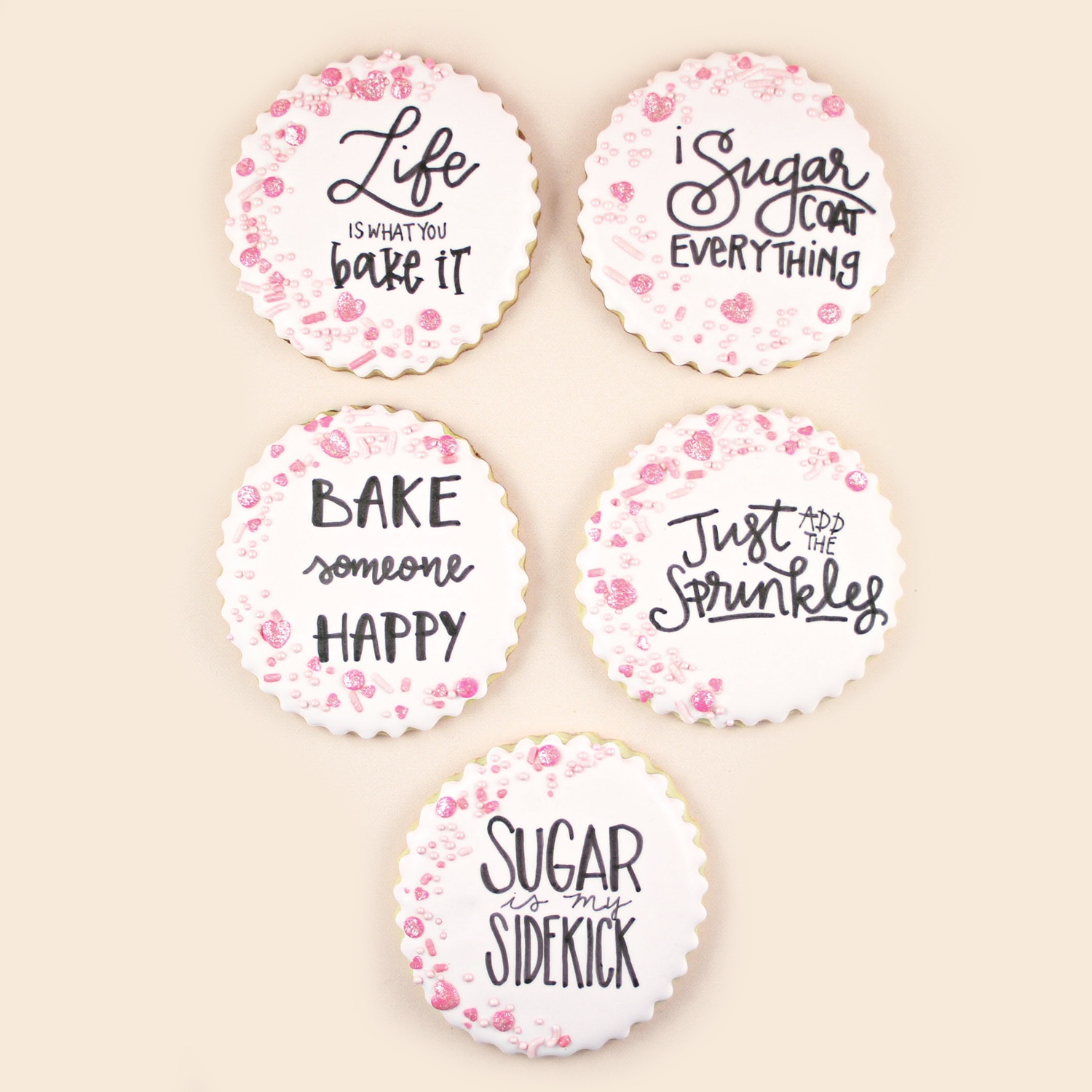 scalloped baked cookies with strawberry milkshake royal icing, pink sprinkle and sugar quotes.