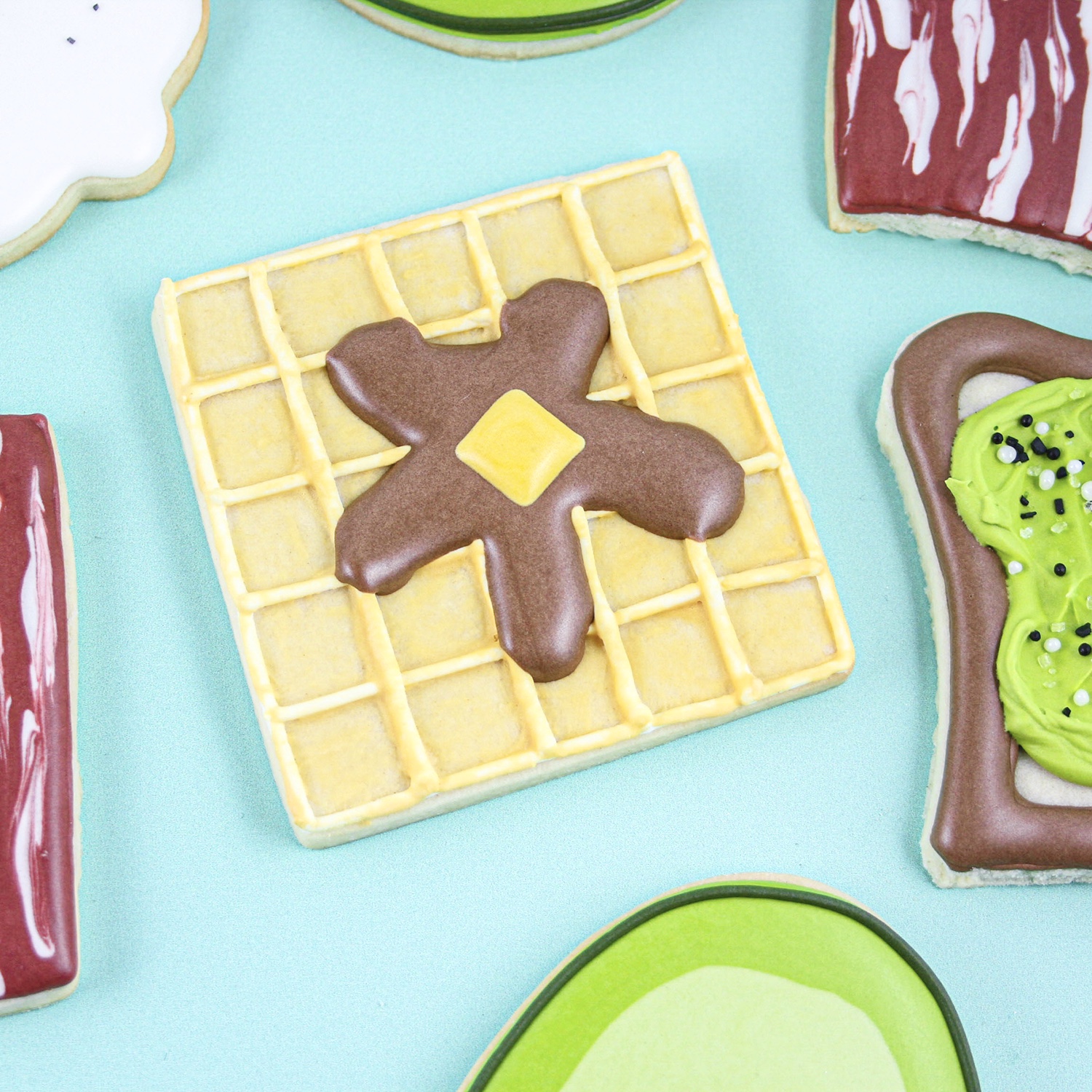 Waffle Cookie with syrup and butter decorated in royal icing.