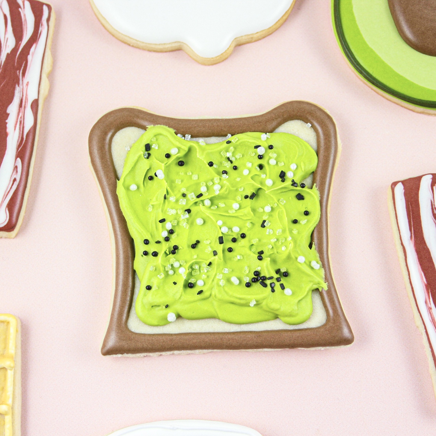 avocado toast decorated cookie in royal icing.