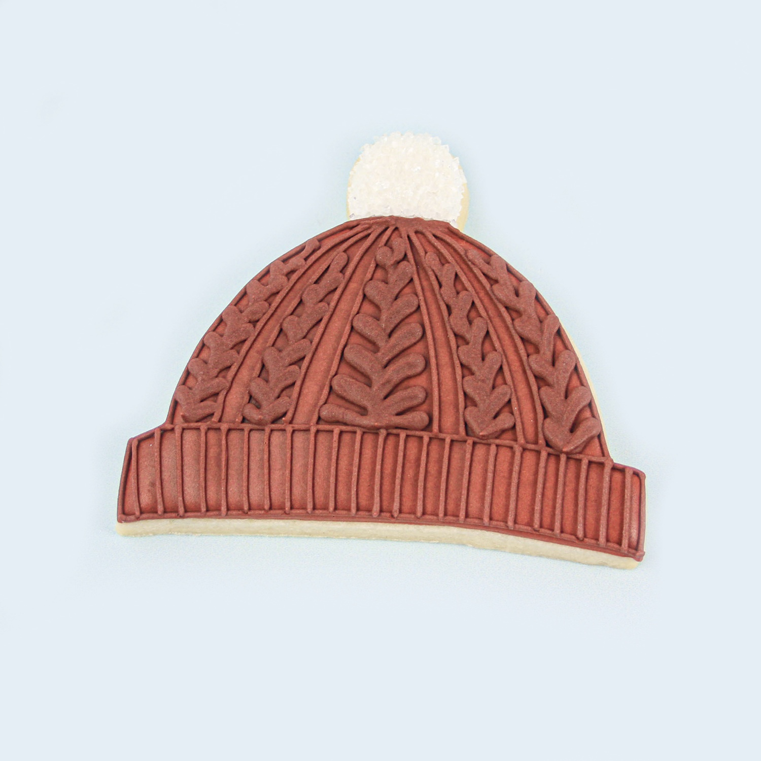 Red Stocking Cap in royal icing, intricate cable knit piping and a crystal sugar pom pom