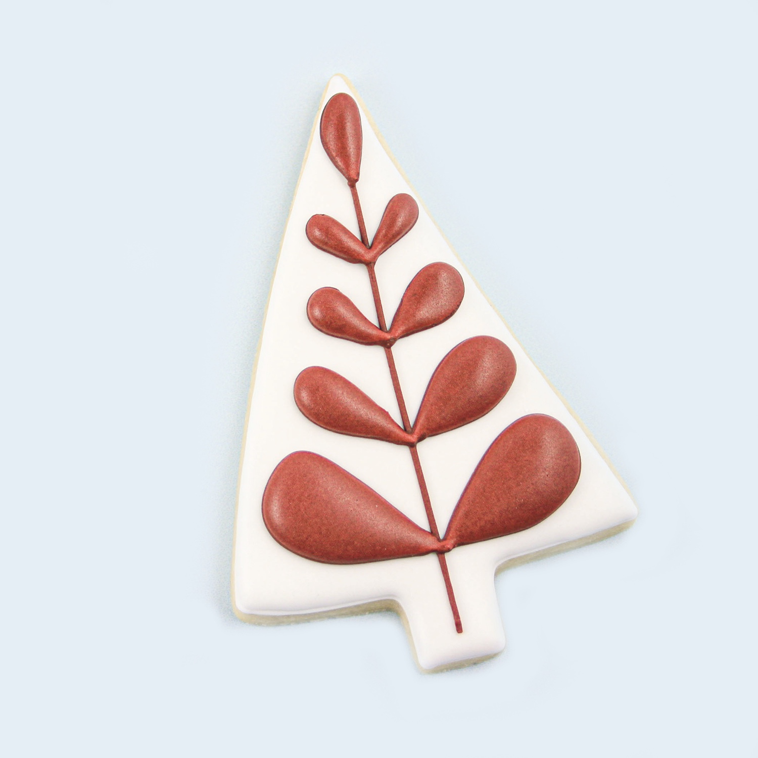 Red tear drop piped christmas tree in royal icing.