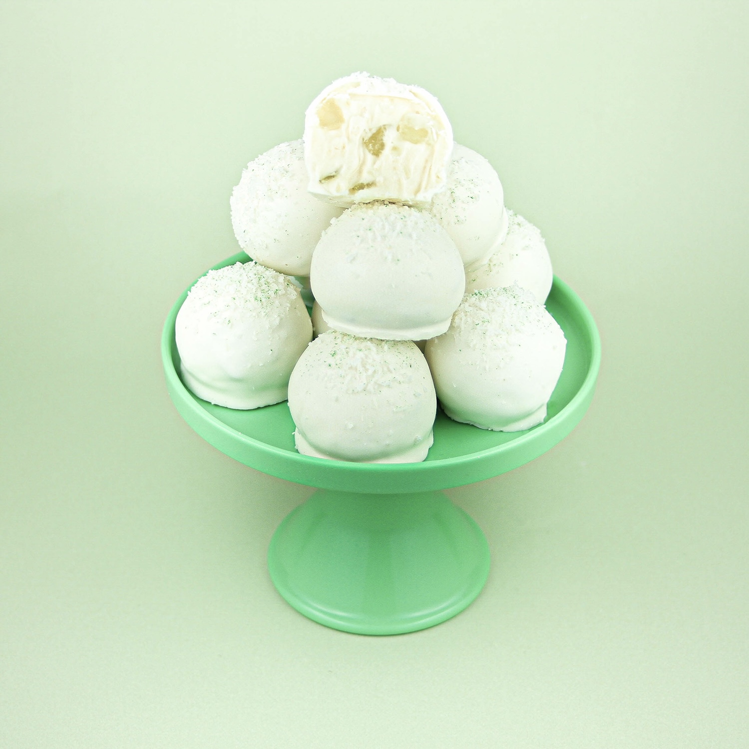 green cake plate with a pyramid of coconut citron bon bons