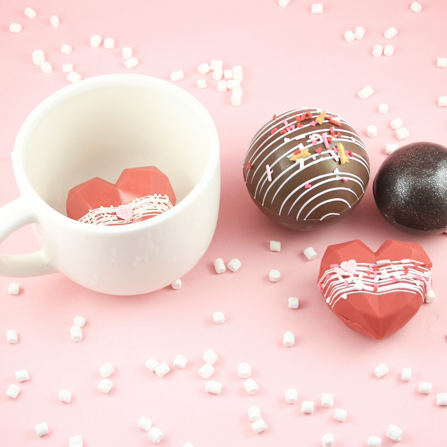 Round and heart shaped chocolate cocoa bombs