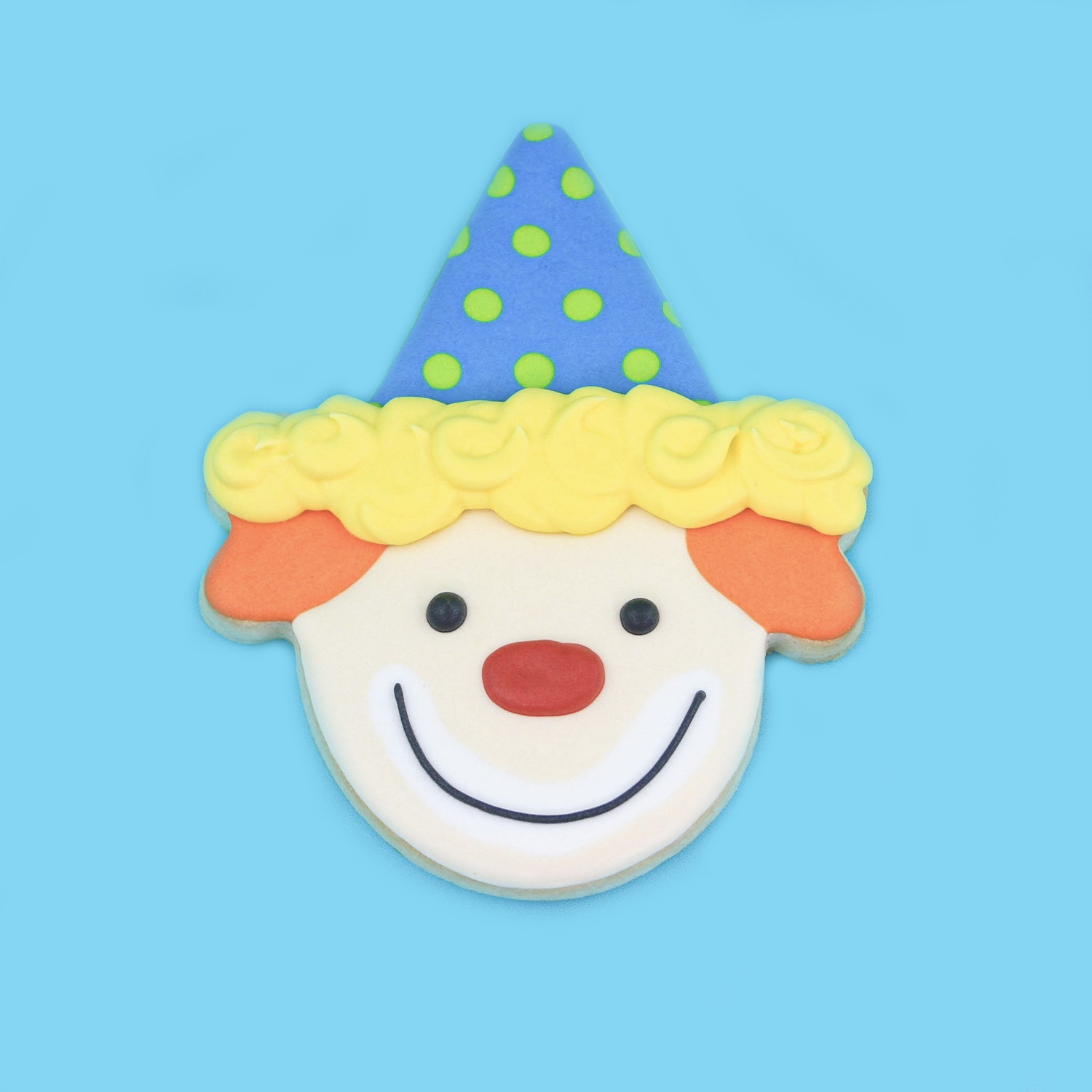 CLown decorated sugar cookie in royal icing using an ice cream cone cookie cutter.