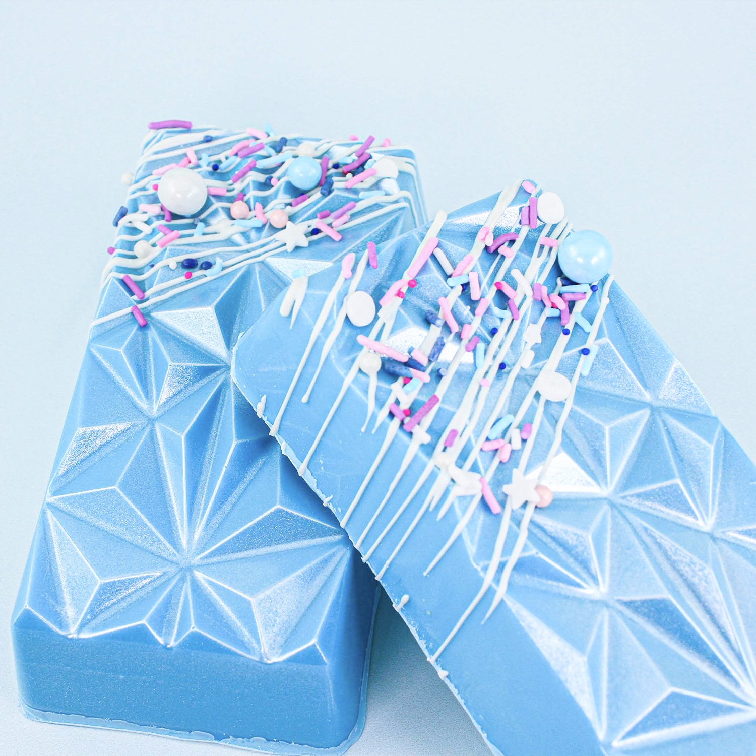 Geometric Cakesicles with a blue outer shell, blue cake dough, rapberry pastry filling and mini marshmallows.