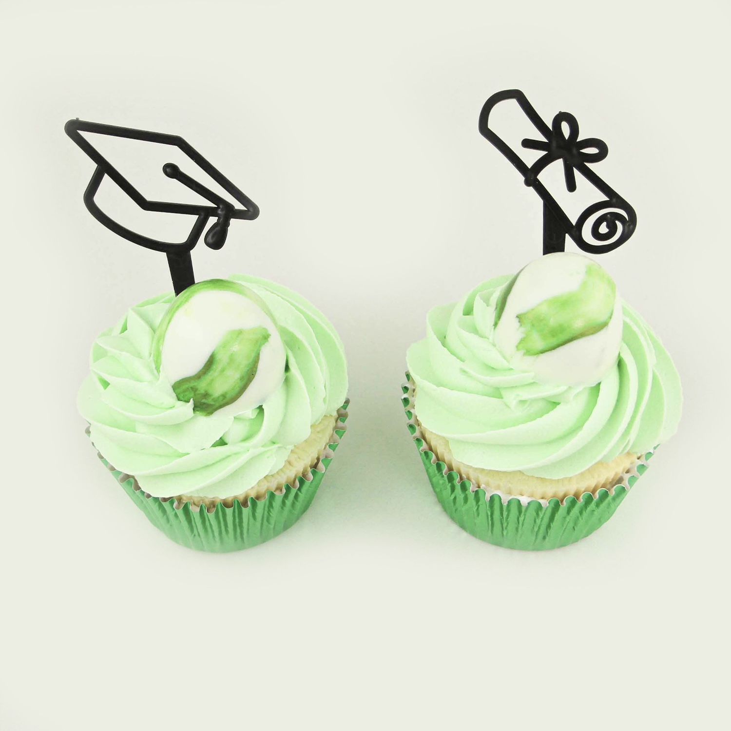 Green swirled buttercream cucpakes with a chocolate shell with hidden sprinkles and a graduation pick