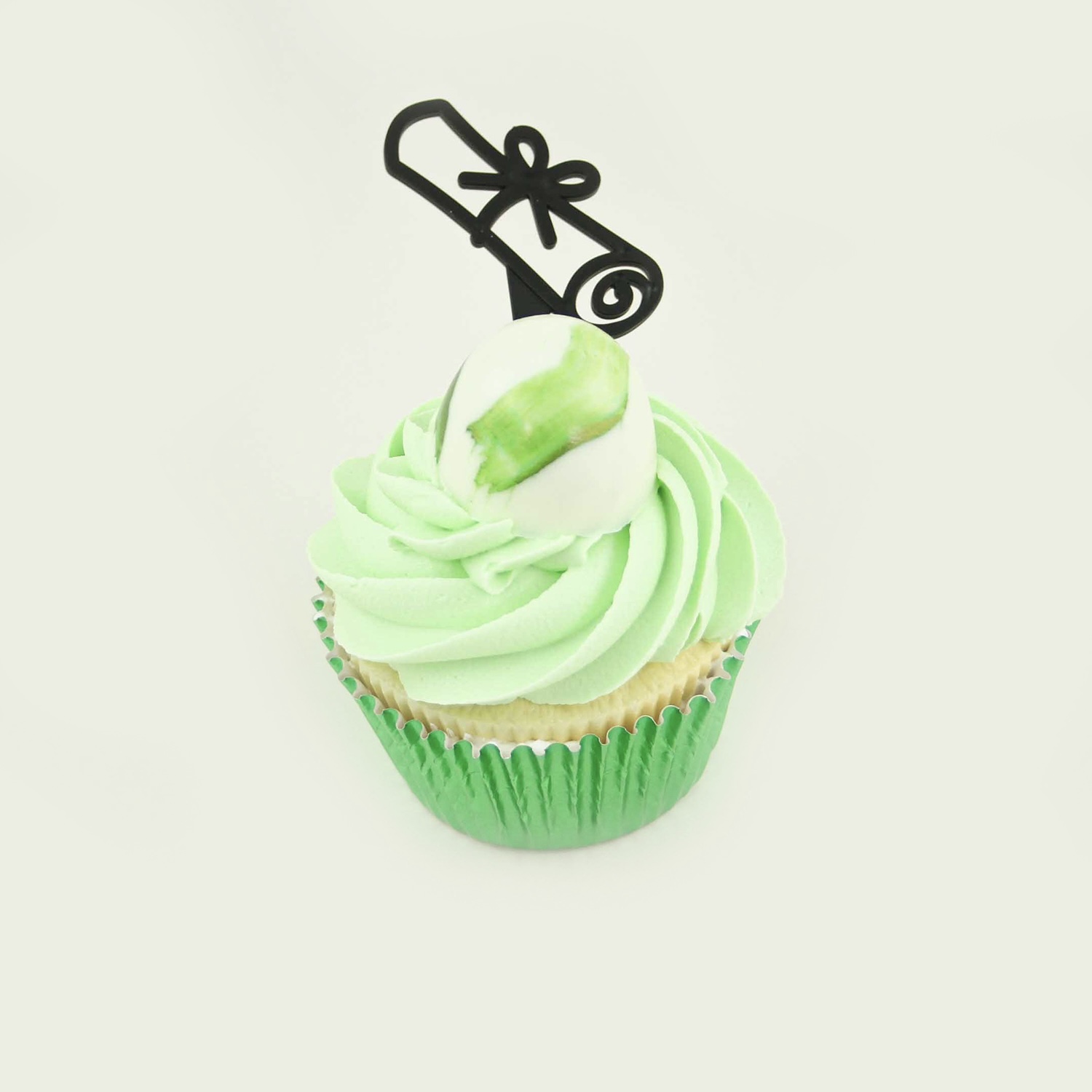 Single green buttercream swirled cupcapke with a chocolate shell holding hidden green coordinating sprinkles and a diploma cupcake topper.