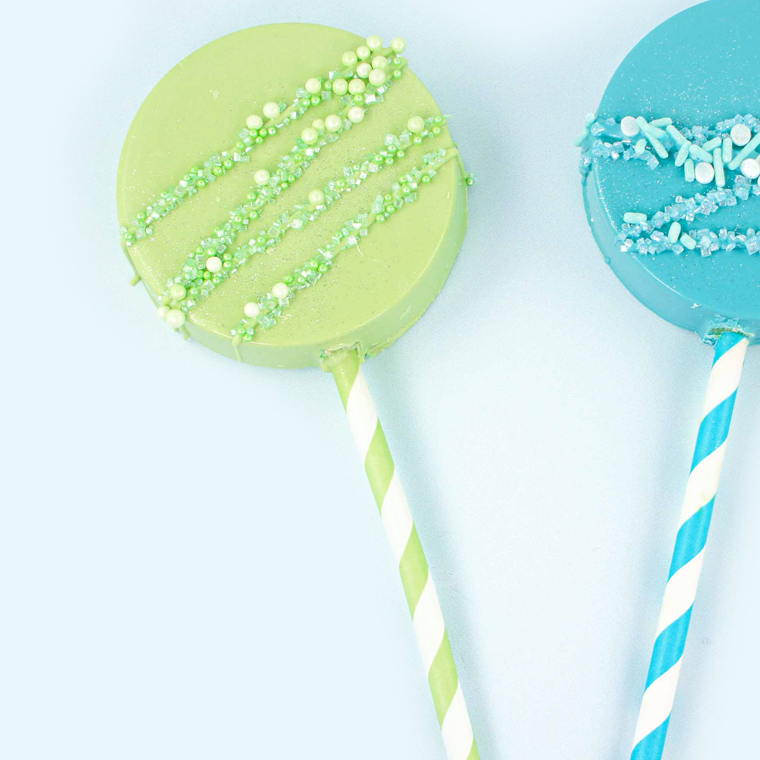 Green Cake Pop molded sucker with green drizzle and green sprinkles and a green striped paper straw sucker stick
