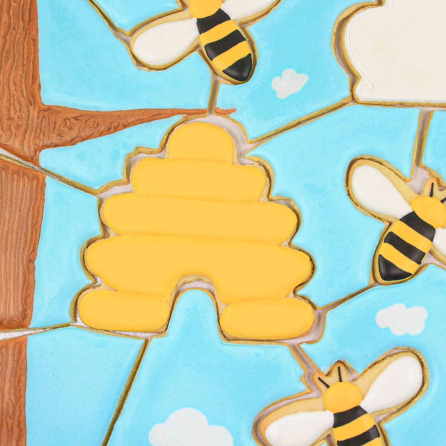 Bumblebee Cookie Puzzle with the tree trunk and beehive decorated in royal icing.