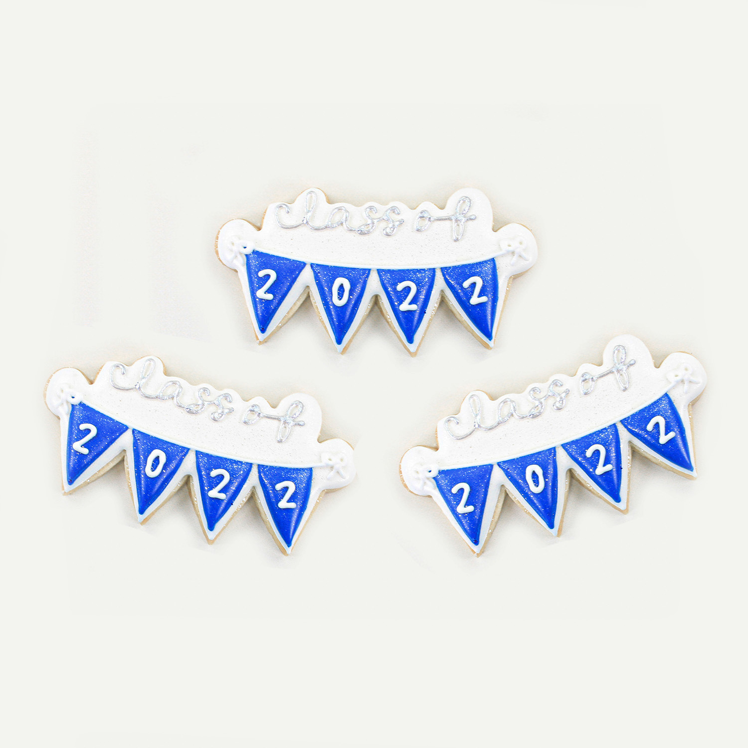 Class of 22 decorated banner sugar cookie in royal blue royal icing and painted in silver metallic edible food paint.