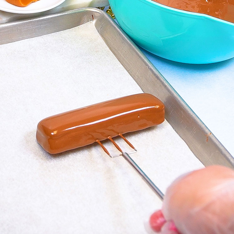 placing homemade candy bar onto parchment paper