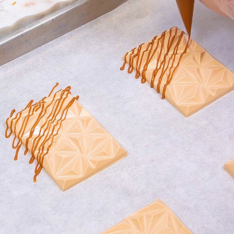 adding cookie butter drizzle to cookie butter chocolate bars