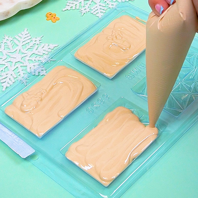 piping cookie butter chocolate into mold