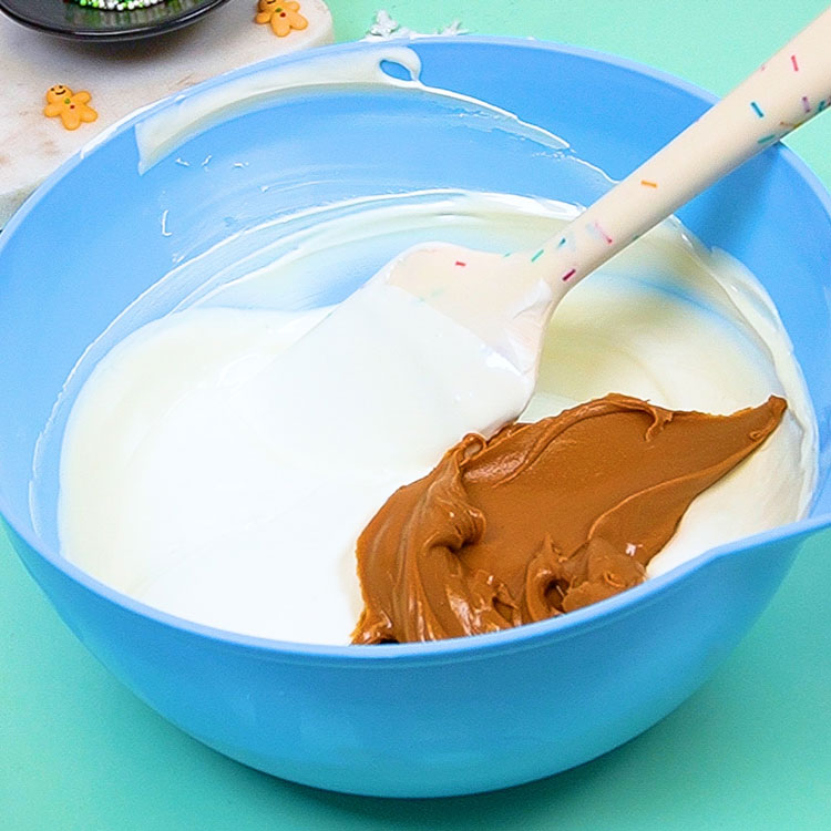 adding cookie butter to melted white chocolate