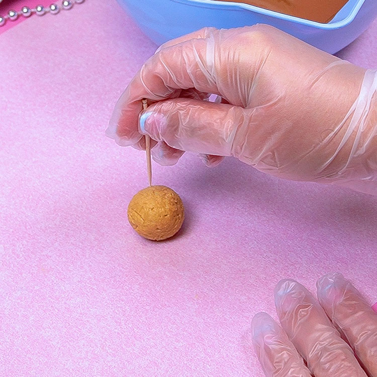 putting toothpick into buckeye