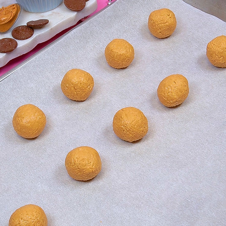 buckeyes rolled into balls on a cookie sheet