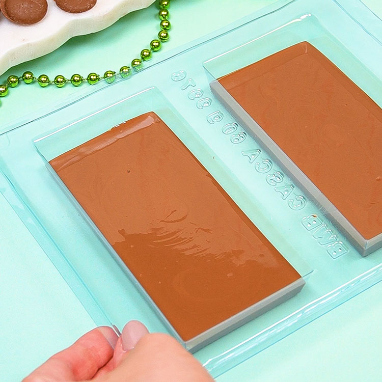 piping milk chocolate in 3 part mold