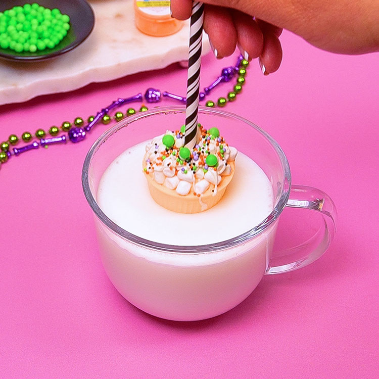 melting hot cocoa bomb cup in a mug of hot milk