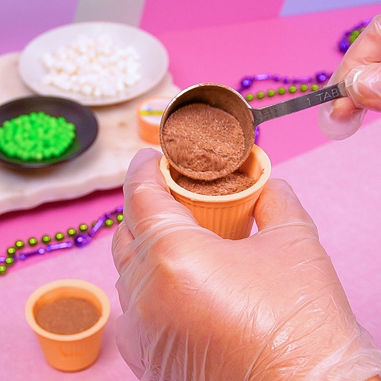 adding hot cocoa mix into chocolate cup