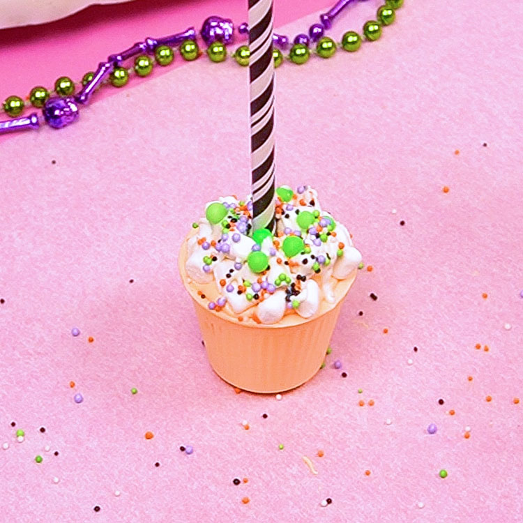 decorating hot cocoa bomb cup with halloween sprinkles