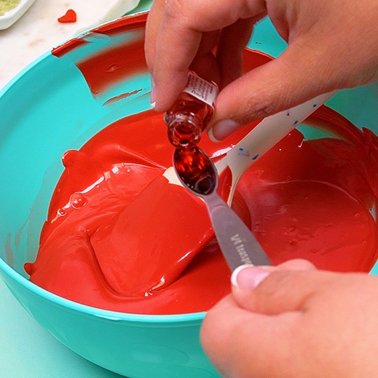 adding cherry flavor to melted red chocolate