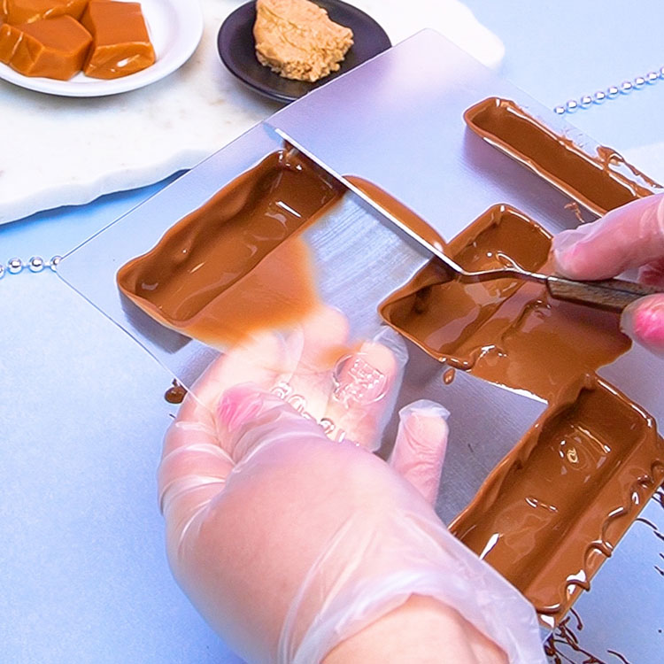 scraping away excess chocolate