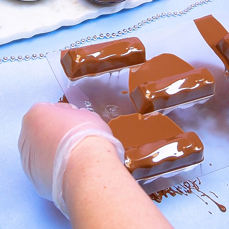 removing excess chocolate from chocolate mold