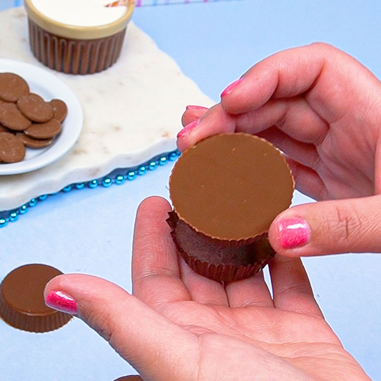 placing chocolate into candy cup liner