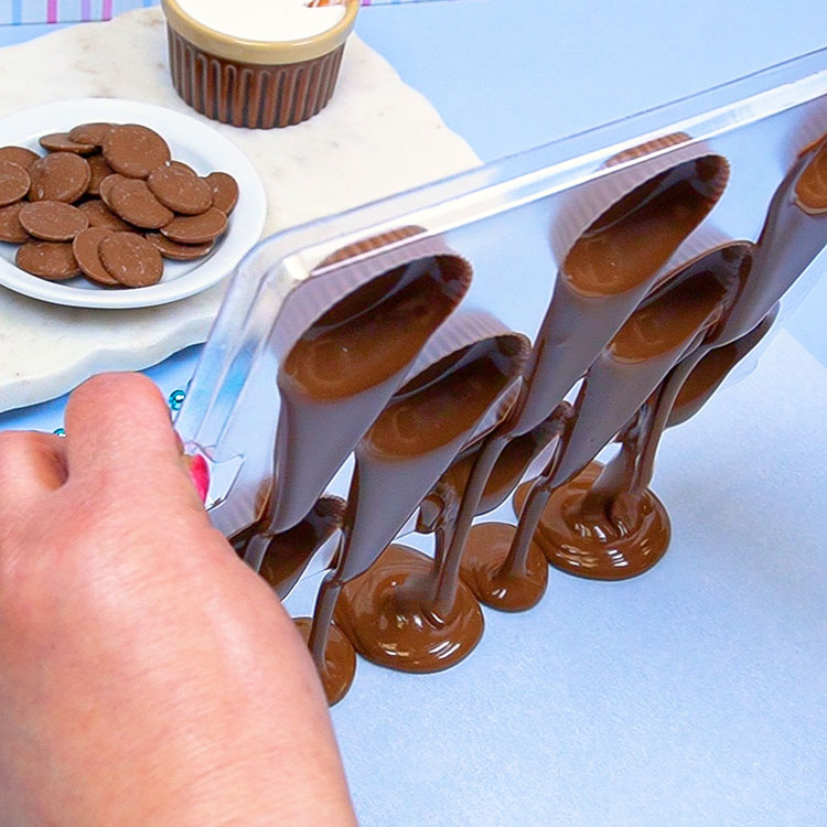 dumping out excess chocolate from chocolate mold