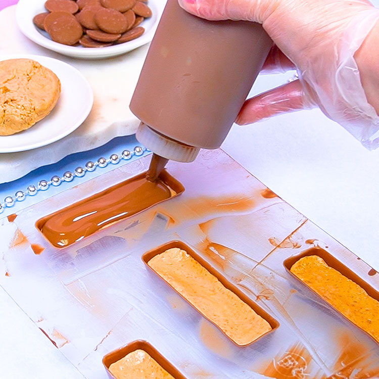 sealing homemade candy bar with melted milk chocolate