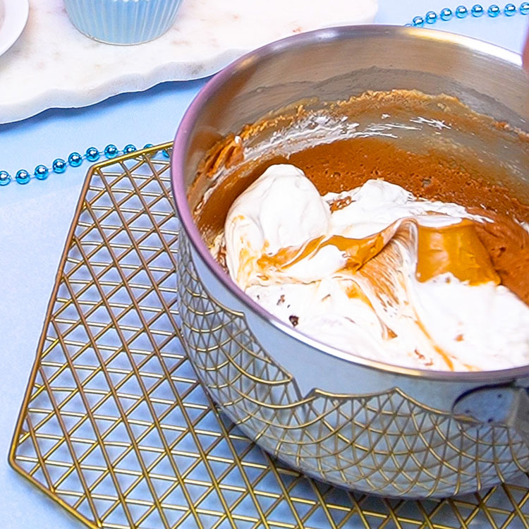 adding peanut butter and marshmallow fluff to pan