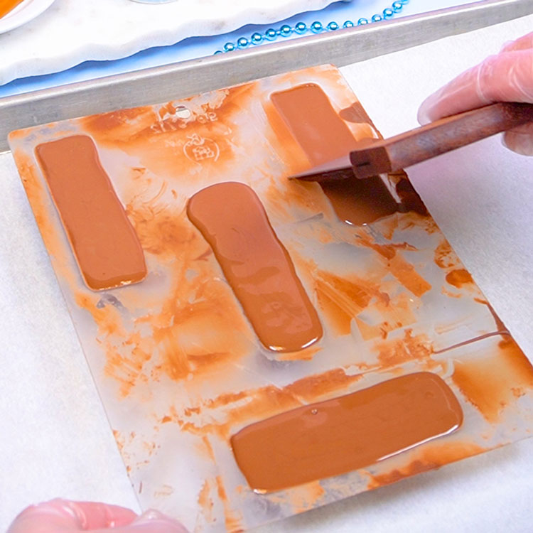 removing excess chocolate from chocolate mold