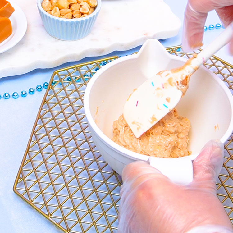 mixing peanuts into nougat