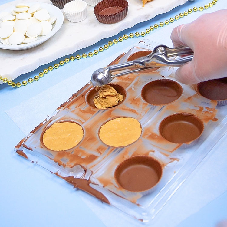 filling chocolate shells with peanut butter candy center