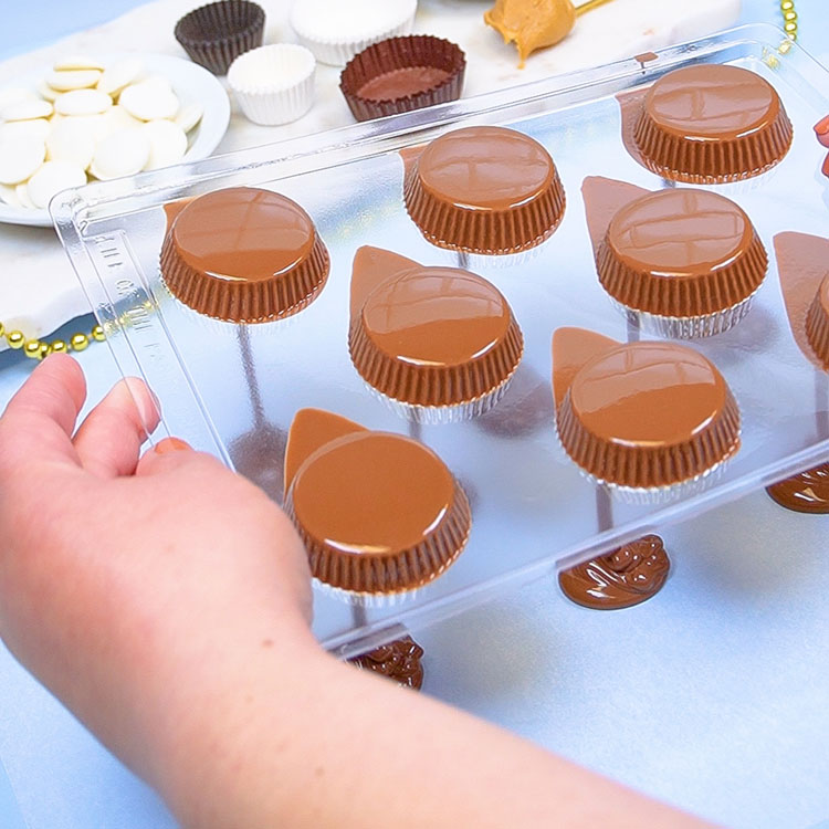 dumping excess chocolate out of chocolate mold