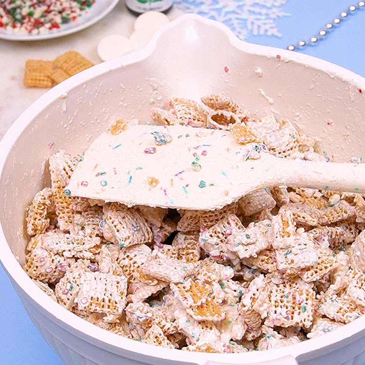 adding chocolate mixture to chex cereal