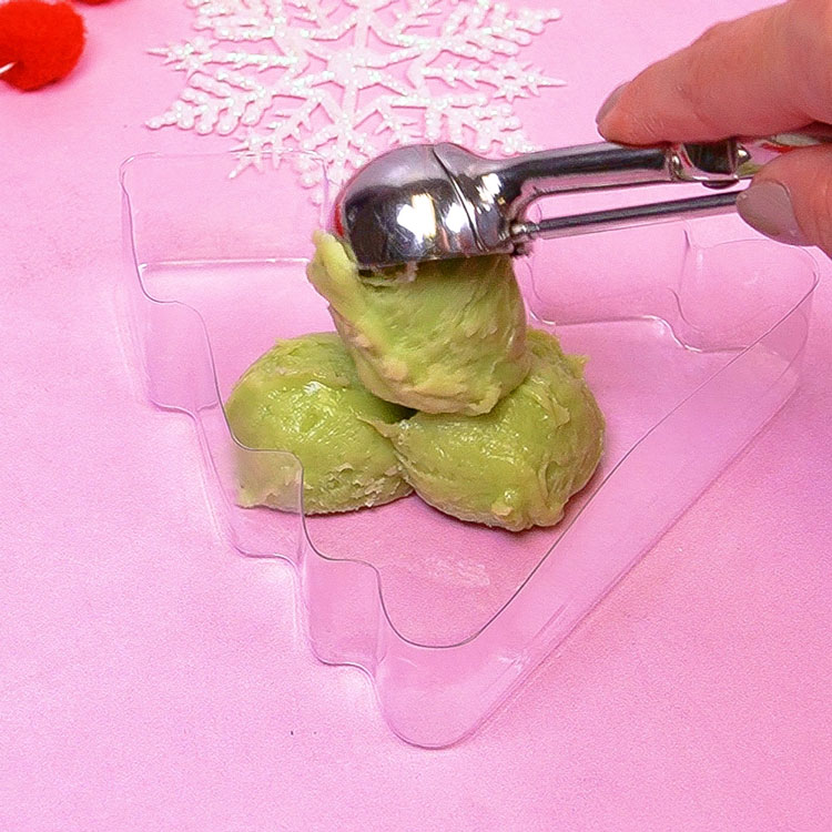 scooping fudge mixture into christmas tree box