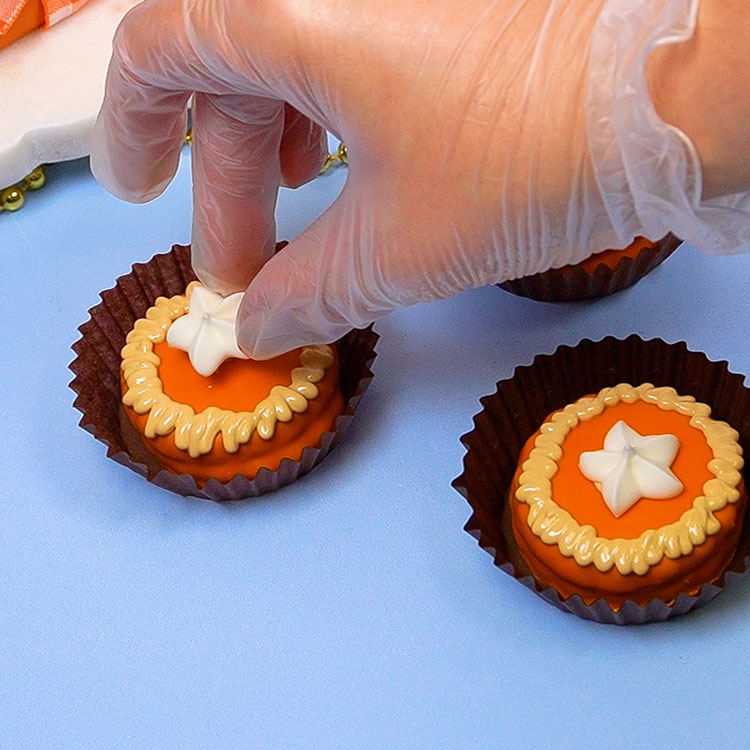 adding whipped cream decoration to cookie